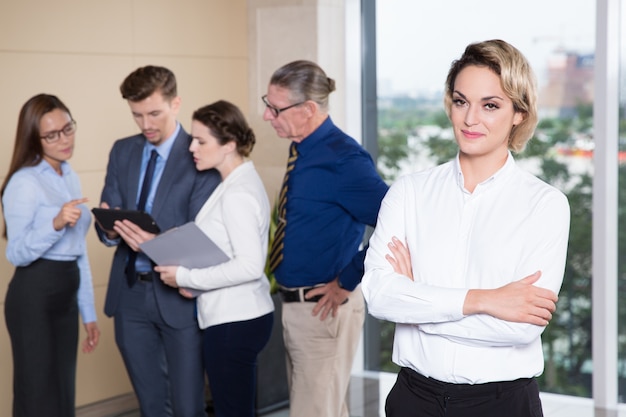 Successful Businesswoman Standing in Front of Team