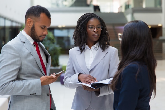 Successful diverse business people discussing contract