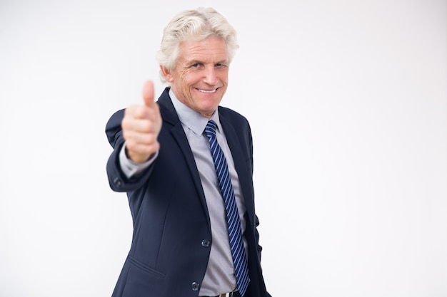 Successful senior businessman showing thumbs up