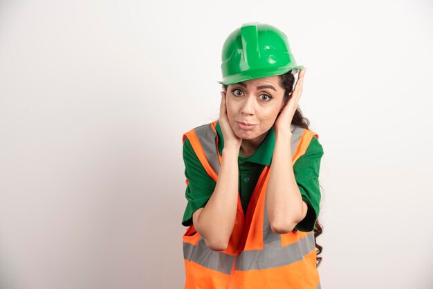 Successful woman in hardhat wearing uniform . High quality photo