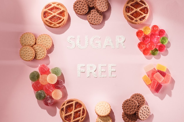 Free photo sugar free cakes and marmalades . diet food. top view on pink table background. healthy concept.