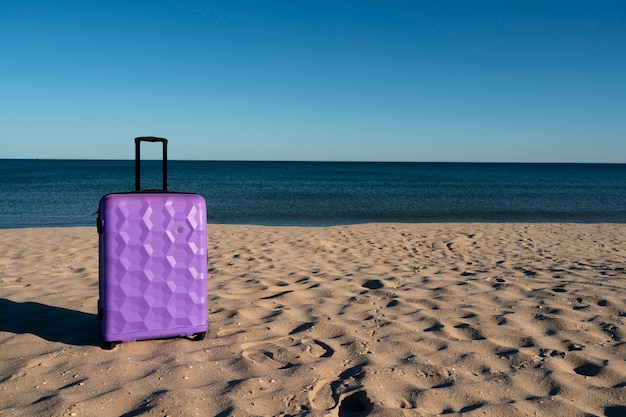 Free Photo suitcase with wheels on beach