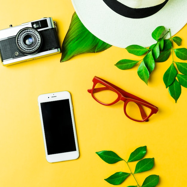 Summer accessories on yellow background