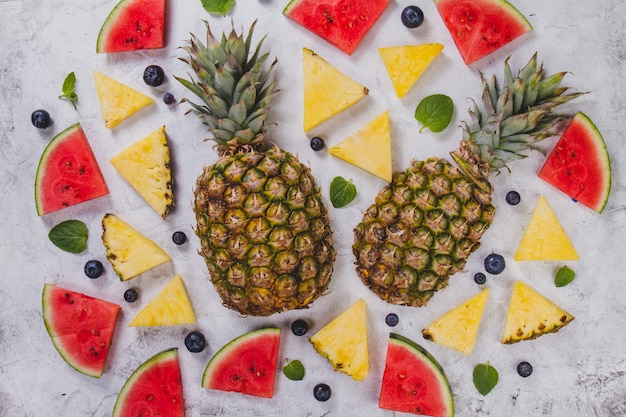 Free Photo summer background with portions of pineapple and watermelon