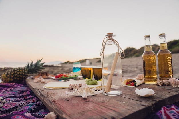 Free photo summer beach scene with drinks on plank