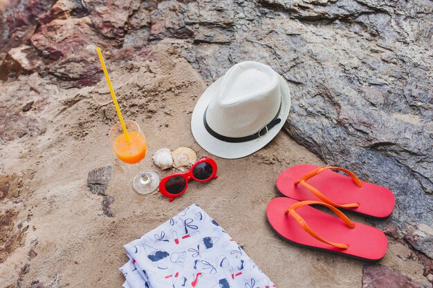 Summer composition with decorative items on sandy surface