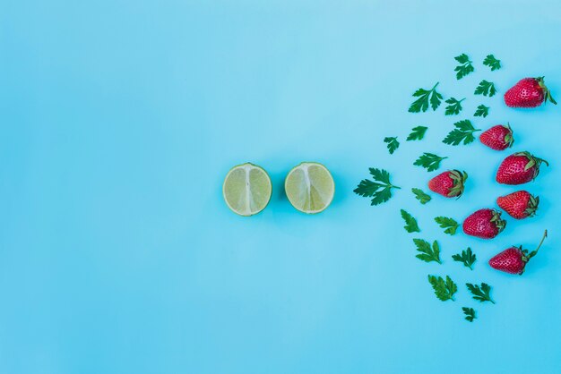 Summer composition with decorative strawberries, limes and parsley