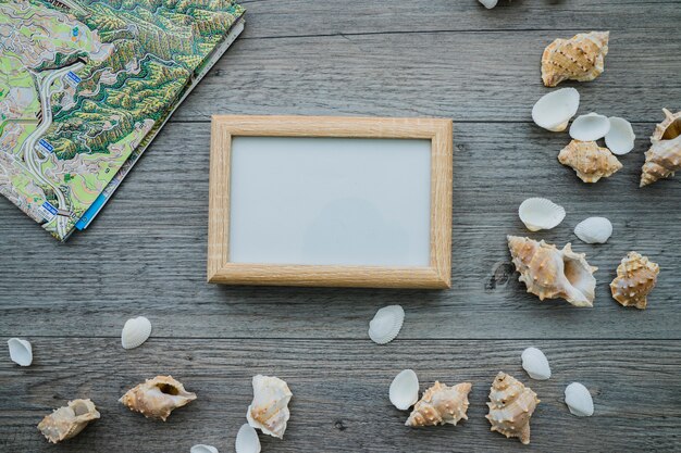 Summer composition with frame, map and seashells