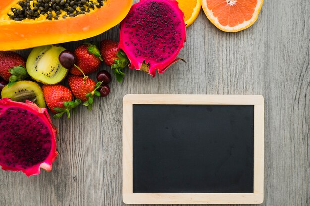 Summer composition with fruits and blank slate