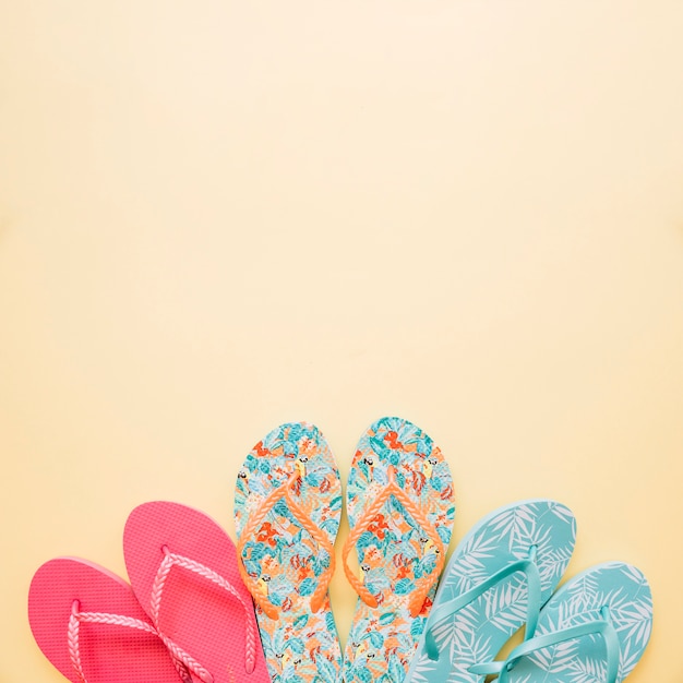 Free Photo summer concept with three pairs of flip flops