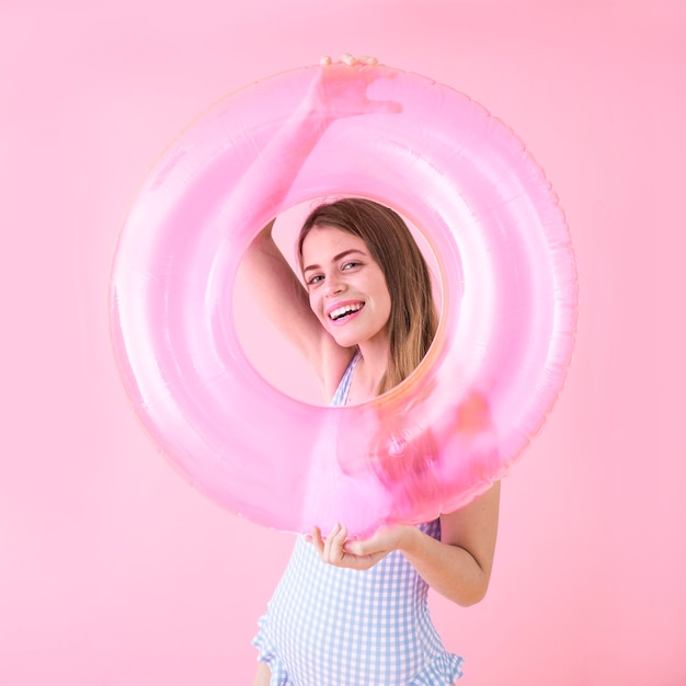 Free Photo summer fashion concept with woman holding inflatable ring