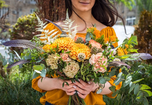 summer flowers bouquet in girl hands