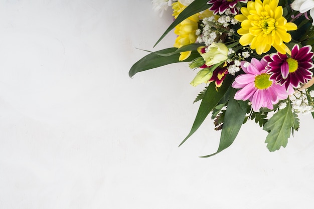 Free photo summer flowers bunch placed on grey desk