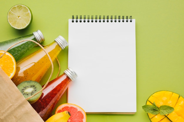 Free Photo summer fruit and juices with clipboard copyspace