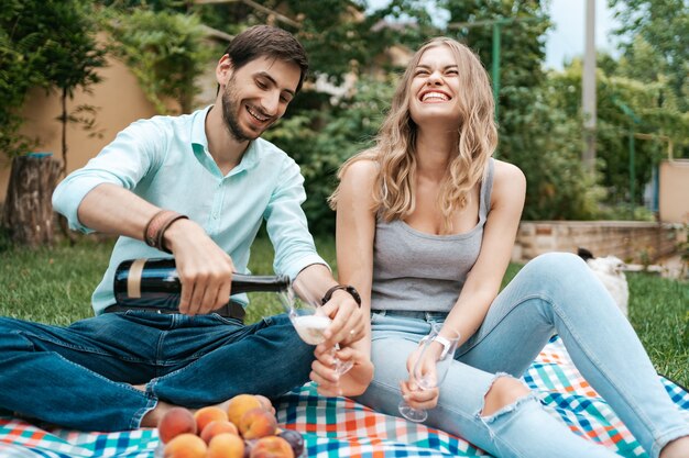 Summer holidays, people, romance, dating concept, couple drinking sparkling wine while enjoying time together at home on the backyard