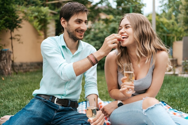 Summer holidays, people, romance, dating concept, couple drinking sparkling wine while enjoying time together at home on the backyard