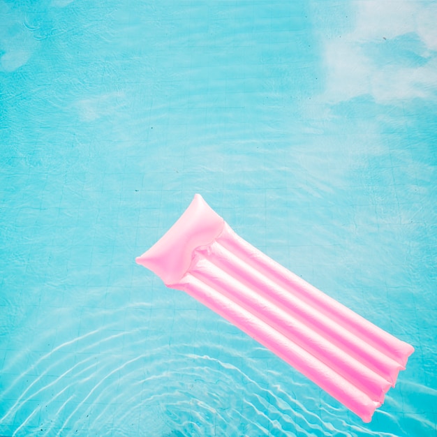 Summer and pool concept with pink mattress