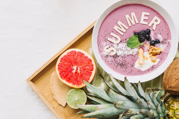 Free Photo summer smoothie in bowl and grapefruit