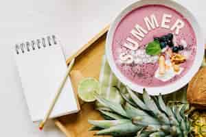 Free photo summer smoothie in bowl and notepad