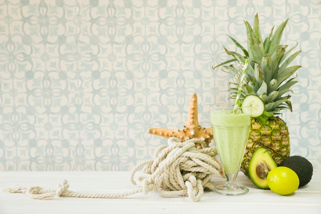 Free Photo summer smoothie with pineapple and rope