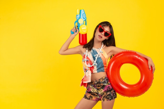 summer young beautiful woman with water gun and Rubber band, songkran holidays