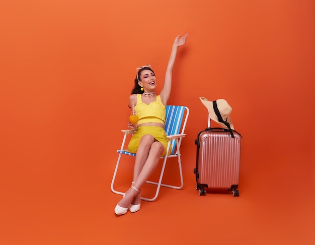 Free photo summertime vacation young woman relaxing and happy outdoors beach sit in deckchair in holiday summer