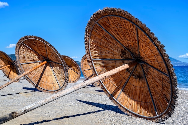 Sun umbrellas left at the beach in Asprovalta, Greece