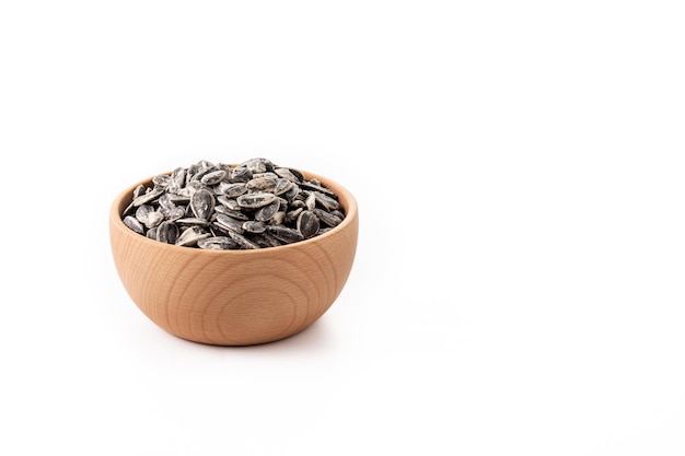 Sunflower seeds in wooden bowl isolated on white background Copy space