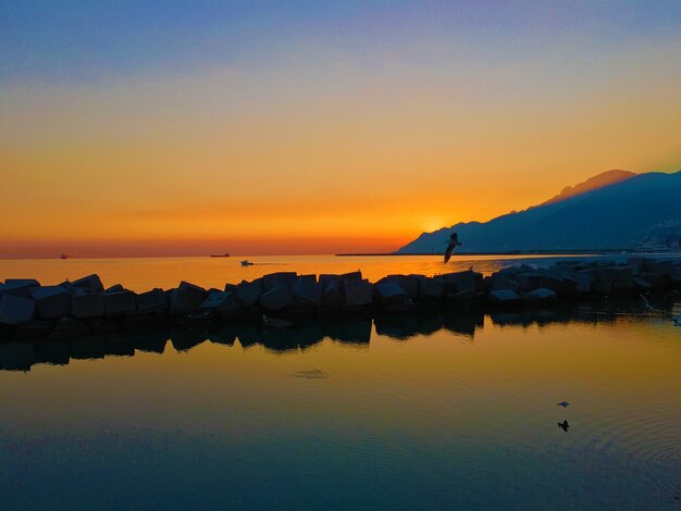 Sunrise scenery in a seashore with a silhouette mountains