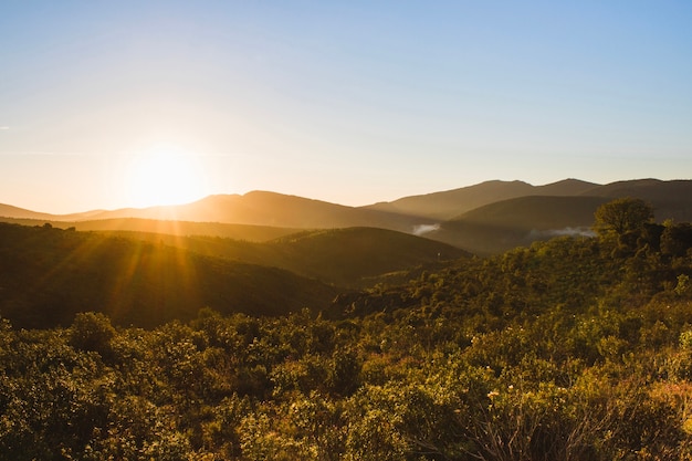 Sunset over hilly countryside