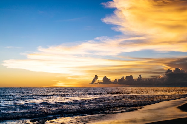 sunset on the ocean. beautiful bright sky, reflection in water, waves.