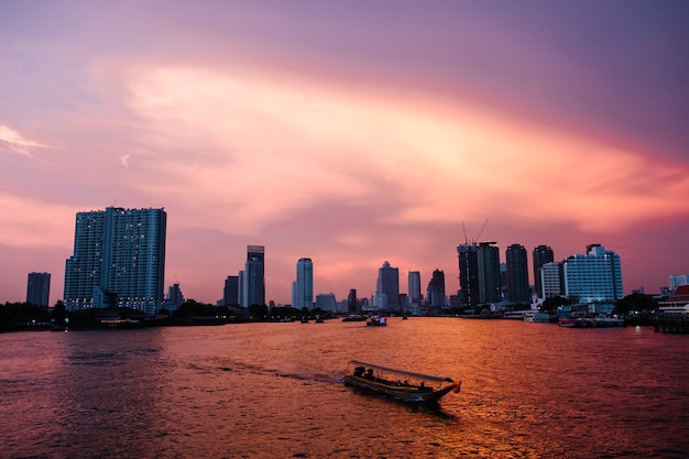 sunset river city and ferry boat in Bangkok background