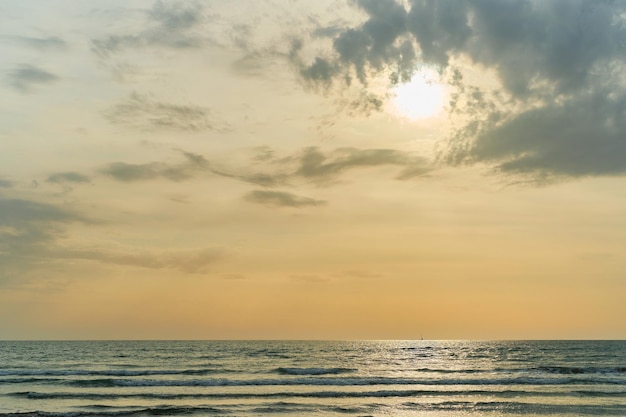 Sunset over the sea after a sandstorm yellow tint from the sand in the air Sea view background with free space