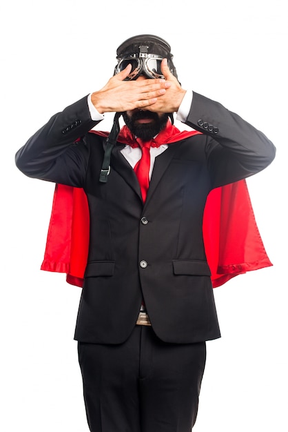 Free photo super hero businessman covering his eyes