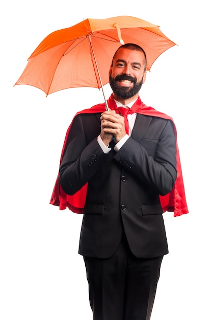 Free photo super hero businessman holding an umbrella