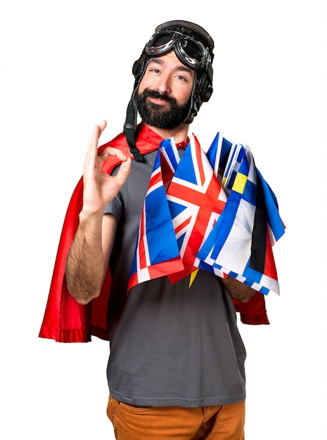 Superhero with a lot of flags making OK sign