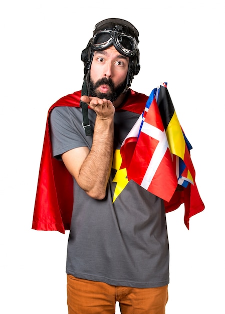 Superhero with a lot of flags sending a kiss