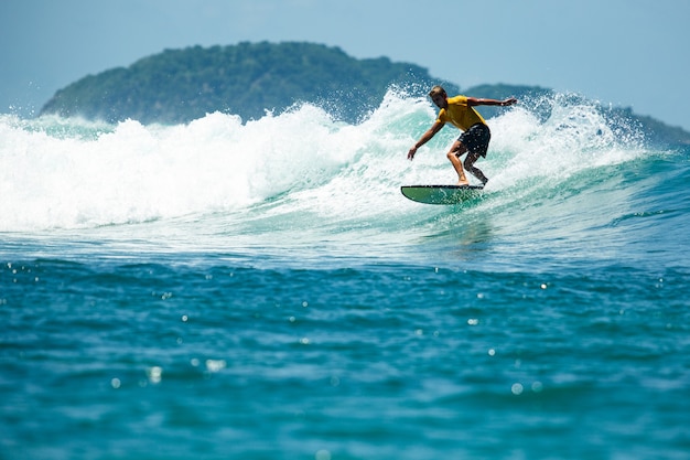 Surfer on a blue wave.