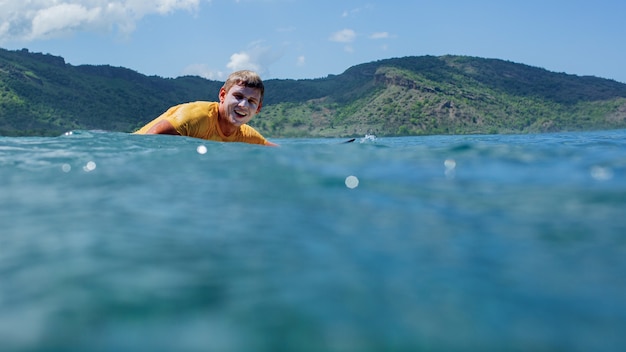 Free photo surfer on a blue wave.