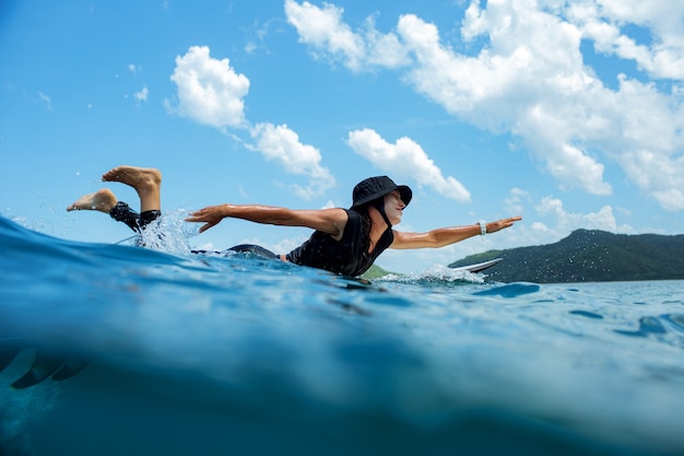 Surfer on a blue wave.