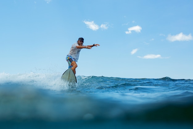 Free Photo surfer on a blue wave.