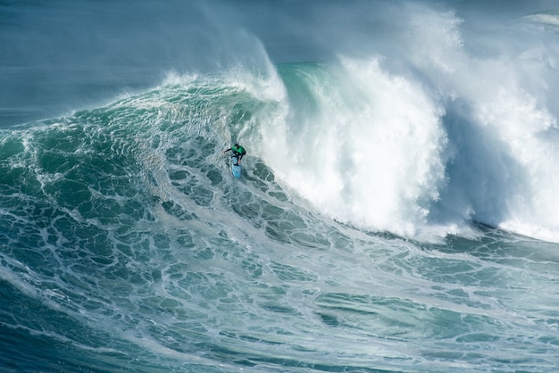 Surfer catching the tall wave