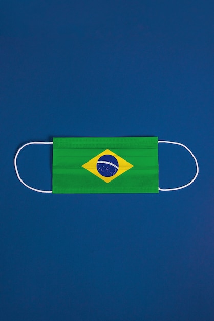 Free photo surgical mask on blue background with brazilian flag