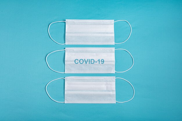 Surgical mask over minimalist blue background