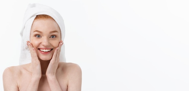 Free Photo surprised beautiful young woman after bath with a towel on her head isolated on white background ski