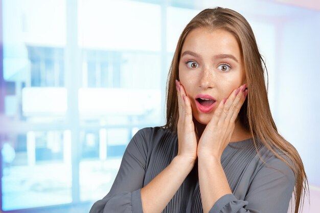 Surprised businesswoman amazed or shocked by unexpected news