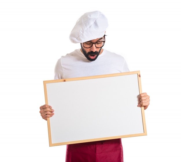 Free photo surprised chef holding empty placard