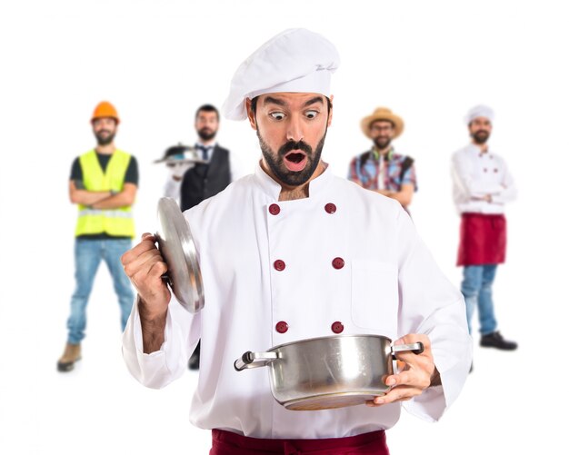 Surprised chef holding a pot