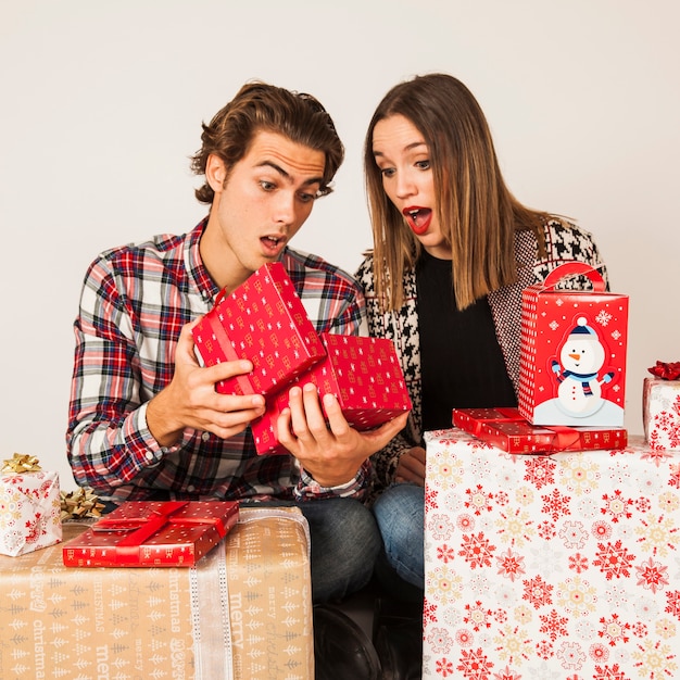 Surprised couple looking into present box