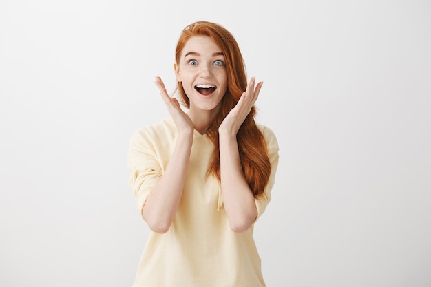 Free photo surprised and excited pretty redhead girl react to awesome news